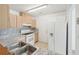 This is an alternate view of the bright kitchen featuring light wood cabinets and white appliances at 742 Redland Dr, Jonesboro, GA 30238