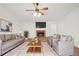 Cozy living room with brick fireplace, ceiling fan, and comfortable seating at 742 Redland Dr, Jonesboro, GA 30238