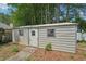 Exterior view of a metal shed featuring a door, two windows, and a corrugated metal exterior at 742 Redland Dr, Jonesboro, GA 30238