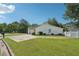 A view of the side yard with well maintained lawn, driveway, and a white fence at 742 Redland Dr, Jonesboro, GA 30238