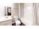 Clean bathroom features a white vanity, toilet, and a shower-tub combination with storage shelves at 117 Joseph E Lowery Nw Blvd, Atlanta, GA 30314