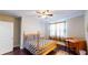 Bedroom boasts hardwood floors, window view, ceiling fan, and desk at 117 Joseph E Lowery Nw Blvd, Atlanta, GA 30314