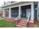 Inviting covered front porch with white columns and a cozy seating area, leading to the entrance of the home at 117 Joseph E Lowery Nw Blvd, Atlanta, GA 30314