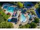 Aerial view of a luxurious community pool featuring slides, lounge chairs, and dining areas at 2425 Hamptons Psge, Alpharetta, GA 30005
