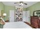 Comfortable bedroom with built-in bookshelves, hardwood floors, and dual closets at 2425 Hamptons Psge, Alpharetta, GA 30005