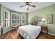 Charming bedroom features bright bay windows, plantation shutters, and hardwood floors at 2425 Hamptons Psge, Alpharetta, GA 30005