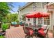 Relaxing outdoor deck featuring comfortable seating, dining area, and string lights at 2425 Hamptons Psge, Alpharetta, GA 30005