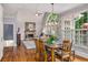Open dining area with stone fireplace, large windows, and modern light fixture at 2425 Hamptons Psge, Alpharetta, GA 30005