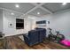 Finished basement featuring a comfortable seating area, TV, and workout equipment at 2425 Hamptons Psge, Alpharetta, GA 30005