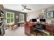 Home office with a large desk, bookshelves, and natural light at 2425 Hamptons Psge, Alpharetta, GA 30005