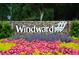 Community sign for 'Windward' with vibrant flower beds and manicured landscaping at 2425 Hamptons Psge, Alpharetta, GA 30005
