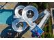 Aerial view of a community water park slide with surrounding lounge chairs and palm trees at 2425 Hamptons Psge, Alpharetta, GA 30005