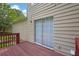 Back deck with wood planks and access to the home's sliding glass door at 2584 Shadowbrook Dr, Decatur, GA 30034