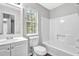 Bathroom with white fixtures, sink, and window at 2584 Shadowbrook Dr, Decatur, GA 30034