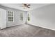 Bright bedroom featuring carpeted floors, ceiling fan, and gray walls providing a cozy and inviting space at 2584 Shadowbrook Dr, Decatur, GA 30034