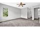 Spacious bedroom with plush carpeting, a ceiling fan, and large window at 2584 Shadowbrook Dr, Decatur, GA 30034