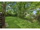 View of the backyard featuring a lush green lawn and mature trees at 515 Cohen St, Atlanta, GA 30310