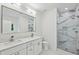 Bright bathroom with double sink vanity, large mirror, toilet, and walk in shower at 515 Cohen St, Atlanta, GA 30310