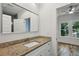 Bathroom vanity with granite counters, undermount sink, and a view into the bedroom at 515 Cohen St, Atlanta, GA 30310