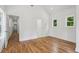 Bright bedroom features hardwood floors, white walls, and two windows providing ample natural light at 515 Cohen St, Atlanta, GA 30310