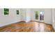 Bright and airy bedroom with hardwood floors, french doors to balcony, and two windows at 515 Cohen St, Atlanta, GA 30310