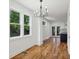 Dining area with hardwood floors and modern chandelier adjacent to kitchen at 515 Cohen St, Atlanta, GA 30310