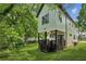 View of the rear of the two-story home featuring a covered porch and a yard with green grass at 515 Cohen St, Atlanta, GA 30310