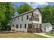 Side view of a two-story home with modern farmhouse design and a small balcony at 515 Cohen St, Atlanta, GA 30310