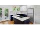 Modern kitchen with navy blue and white cabinets, quartz countertops, stainless steel appliances, and a central island at 515 Cohen St, Atlanta, GA 30310