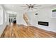Open-concept living room with hardwood floors, modern fireplace, and ample natural light at 515 Cohen St, Atlanta, GA 30310