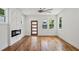 Bright living room featuring fireplace, ceiling fan, and hardwood floors at 515 Cohen St, Atlanta, GA 30310