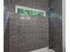 Modern shower features dark grey subway tile and a window allowing natural light at 515 Cohen St, Atlanta, GA 30310