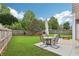 The home's cozy outdoor patio with dining area, surrounded by a beautiful lawn at 5225 Stonehaven Vw, Cumming, GA 30040