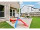 Backyard patio with slide, table, chairs, and grill for outdoor entertaining at 5225 Stonehaven Vw, Cumming, GA 30040