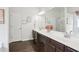 Bathroom features a double sink vanity with large mirrors, neutral walls, and wood look flooring at 5225 Stonehaven Vw, Cumming, GA 30040