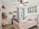 Childs bedroom features a ceiling fan, neutral walls, plush carpeting, and built in shelving at 5225 Stonehaven Vw, Cumming, GA 30040