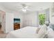 Bright bedroom featuring a ceiling fan, white walls, and a window providing natural light at 5225 Stonehaven Vw, Cumming, GA 30040