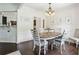 Bright dining room with an oval wooden table, decor, and visible access to other living spaces at 5225 Stonehaven Vw, Cumming, GA 30040