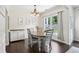 Dining room with dark wood floors, chandelier, and lots of natural light from the large window at 5225 Stonehaven Vw, Cumming, GA 30040