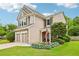 Beautiful two-story home with a stone and siding exterior, complemented by lush landscaping and an American flag at 5225 Stonehaven Vw, Cumming, GA 30040