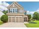 Charming two-story home with a stone and shingle facade, an attached two-car garage and a well-manicured lawn at 5225 Stonehaven Vw, Cumming, GA 30040