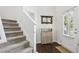 Inviting foyer boasts a white front door, staircase, and stylish decor, creating a welcoming entrance at 5225 Stonehaven Vw, Cumming, GA 30040