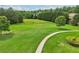 Expansive green space with walking paths and seating within a well-manicured community at 5225 Stonehaven Vw, Cumming, GA 30040