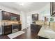 Well-equipped kitchen featuring granite countertops, stainless steel appliances, and dark wood cabinetry at 5225 Stonehaven Vw, Cumming, GA 30040