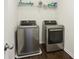 Efficient laundry room complete with updated machines and a practical shelving unit at 5225 Stonehaven Vw, Cumming, GA 30040
