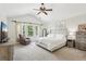 Main bedroom featuring a ceiling fan, comfortable seating, and natural light from the window at 5225 Stonehaven Vw, Cumming, GA 30040