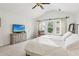 Bright main bedroom with large windows, neutral walls, plush carpeting, and ensuite access at 5225 Stonehaven Vw, Cumming, GA 30040