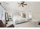 Main bedroom with ceiling fan, neutral walls, and plush carpet. Features art and decor at 5225 Stonehaven Vw, Cumming, GA 30040