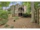 Spacious backyard featuring mature trees, a wooden fence, and multi-level decks at 604 Timm Valley Ne Rd # A, Atlanta, GA 30305