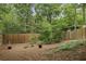 Large fenced backyard with mature trees and a gently sloping lawn at 604 Timm Valley Ne Rd # A, Atlanta, GA 30305